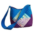 Bolsa de mano de patchwork terminada en azul turquesa y morado con bloque log cabin en tonos pastel y asa al hombro